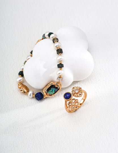 QL-J0325-2 Lapis Lazuli Daisy Zircon Ring. The deep blue lapis lazuli resembles the midsummer sky, while the vintage cross pattern evokes French elegance.