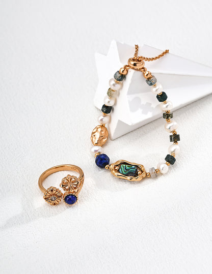 QL-J0325-2 Lapis Lazuli Daisy Zircon Ring. The deep blue lapis lazuli resembles the midsummer sky, while the vintage cross pattern evokes French elegance.